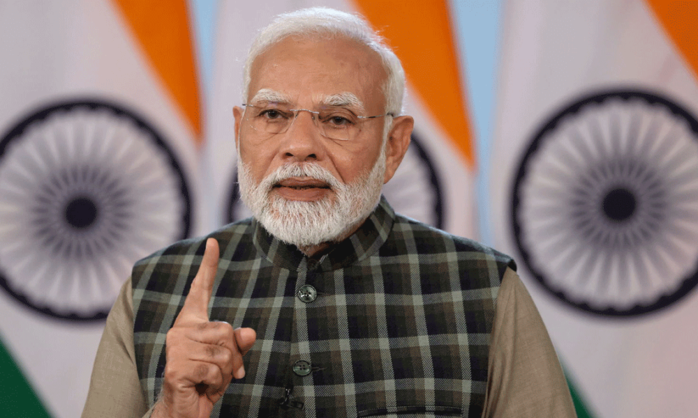 Portrait of Narendra Modi, Prime Minister of India, delivering a speech.